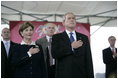 President George W. Bush and Mrs. Laura Bush stand for the National Anthem during the Christening Ceremony of the George H.W. Bush (CVN 77) in Newport News, Virginia, Saturday, Oct. 7, 2006.