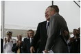 President George W. Bush hugs his father, Former President George H. W. Bush, after delivering remarks at the Christening Ceremony for the George H.W. Bush (CVN 77) in Newport News, Virginia, Saturday, Oct. 7, 2006.