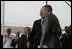 President George W. Bush hugs his father, Former President George H. W. Bush, after delivering remarks at the Christening Ceremony for the George H.W. Bush (CVN 77) in Newport News, Virginia, Saturday, Oct. 7, 2006.