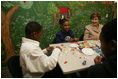 Mrs. Laura Bush sculpts clay with participants of the Communications Through Art program at the Knox County Public Defenders Community Law Office in Knoxville, Tennessee, Wednesday, October 11, 2006, as part of the President's Helping America's Youth program. Communications Through Art program uses the arts to help young people express themselves and to deal with important issues of the day.