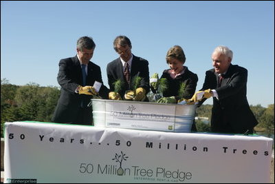 Mrs. Laura Bush is joined by, from left, U.S. Department of Agriculture Secretary Mike Johanns; John Rosenow, president of the National Arbor Day Foundation, and Andy Taylor, chairman and CEO of Enterprise Rent-A-Car, as they plant White Pine saplings Thursday, October 11, 2006, during a ceremony for the Enterprise 50 Million Tree Pledge in St. Louis, Missouri. Enterprise Rent-A-Car donated $50 million to the National Arbor Day Foundation to plant 50 million trees in National Forests over the next 50 years. The White Pine saplings planted at the ceremony will be re-planted permanently in the Mark Twain National Forest in southern Missouri.