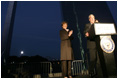 Mrs. Laura Bush applauds Chairman and CEO William McNamara of Macy's Midwest, as he delivers welcoming remarks during the Arch Lighting for Breast Cancer Awareness event in Thursday, Oct. 12, 2006, in St. Louis. The Gateway Arch was illuminated in pink in honor of Breast Cancer Awareness Month.