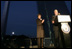 Mrs. Laura Bush applauds Chairman and CEO William McNamara of Macy's Midwest, as he delivers welcoming remarks during the Arch Lighting for Breast Cancer Awareness event in Thursday, Oct. 12, 2006, in St. Louis. The Gateway Arch was illuminated in pink in honor of Breast Cancer Awareness Month.