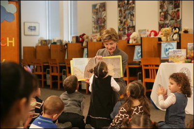 A little reader takes a closer look as Mrs. Laura Bush reads the children's book, "I Love You, Little One," by Nancy Tafuri during a visit to the Jenna Welch and Laura Bush Community Library in El Paso, Texas, Wednesday, Oct. 18, 2006. Since the library opened in 2003, the number of programs and attendance has tripled. Through the past year, the Library hosted 349 programs for more than 10,000 participants.