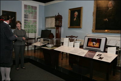 Mrs. Laura Bush listens to David Temple, actor portraying Benjamin Franklin, Wednesday, October 18, 2006, as he guides her through the Benjamin Franklin: In Search of a Better World Exhibit, at the Houston Museum of Natural Science in Houston, Texas. The exhibition, a blend of art, history, science, and material culture, features Franklin's original possessions, including many items never publicly displayed, iconic works of art and rare documents. It also features interactive devices that enable visitors to explore Franklin's eighteenth-century world using twenty-first-century technology.