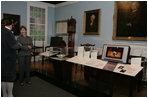 Mrs. Laura Bush listens to David Temple, actor portraying Benjamin Franklin, Wednesday, October 18, 2006, as he guides her through the Benjamin Franklin: In Search of a Better World Exhibit, at the Houston Museum of Natural Science in Houston, Texas. The exhibition, a blend of art, history, science, and material culture, features Franklin's original possessions, including many items never publicly displayed, iconic works of art and rare documents. It also features interactive devices that enable visitors to explore Franklin's eighteenth-century world using twenty-first-century technology.