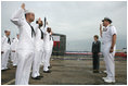 Mrs. Laura Bush observes a U.S. Navy Re-enlistment Ceremony Saturday, September 9, 2006, as Rear Admiral Fox, Director, White House Military Office, administers the oath to sailors prior to the Commissioning Ceremony of the USS Texas submarine in Galveston, Texas.