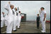 Mrs. Laura Bush observes a U.S. Navy Re-enlistment Ceremony Saturday, September 9, 2006, as Rear Admiral Fox, Director, White House Military Office, administers the oath to sailors prior to the Commissioning Ceremony of the USS Texas submarine in Galveston, Texas.