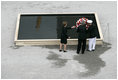 After laying a wreath in the north tower reflecting pool, President George W. Bush and Laura Bush walk through the World Trade Center site to lay a second wreath in the south tower reflecting pool to commemorate the fifth anniversary of the September 11th terrorist attacks in New York City Sunday, September 10, 2006.