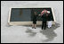 After laying a wreath in the north tower reflecting pool, President George W. Bush and Laura Bush walk through the World Trade Center site to lay a second wreath in the south tower reflecting pool to commemorate the fifth anniversary of the September 11th terrorist attacks in New York City Sunday, September 10, 2006.