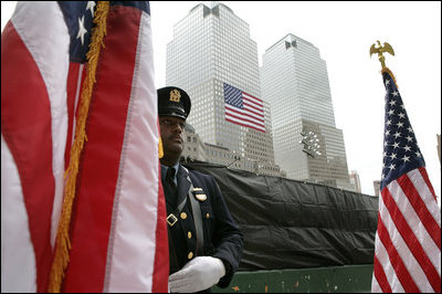 A police officer stands at attention at Ground Zero during the ceremonies marking the fifth anniversary of the September 11th terrorist attacks in New York City Sunday, September 10, 2006.