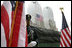 A police officer stands at attention at Ground Zero during the ceremonies marking the fifth anniversary of the September 11th terrorist attacks in New York City Sunday, September 10, 2006.