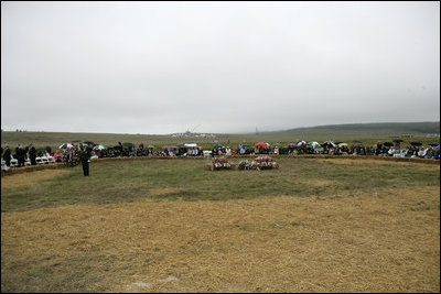 To commemorate the fifth anniversary of the September 11th attacks, family members gather for a wreath laying ceremony Monday, September 11, 2006, in the open field where United flight 93 crashed after passengers rose up against the terrorist hijackers. President George W. Bush and Laura Bush placed a wreath at the crash site.