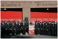 President George W. Bush and Laura Bush stand with New York City First Responders at the Fort Pitt Firehouse for a moment of silence Monday, September 11, 2006, in New York City to commemorate the fifth anniversary of the September 11th terrorist attacks. Also pictured is a door from Ladder 18, which was destroyed in the collapse of the World Trade Center.