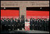 President George W. Bush and Laura Bush stand with New York City First Responders at the Fort Pitt Firehouse for a moment of silence Monday, September 11, 2006, in New York City to commemorate the fifth anniversary of the September 11th terrorist attacks. Also pictured is a door from Ladder 18, which was destroyed in the collapse of the World Trade Center.