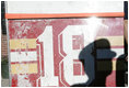 Shadows from New York City First Responders are cast upon a door of Ladder 18, one of the fire trucks destroyed in the September 11th terrorist attacks, during a moment of silence at the Fort Pitt Firehouse in New York City Monday, September 11, 2006.