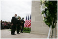 President George W. Bush and Laura Bush, accompanied by Sgt. Timothy Boyd of the Military District of Washington, stand before a memorial wreath Monday, Sept. 11, 2006, during a moment of silence at the Pentagon in Arlington, Va., to commemorate the fifth anniversary of Sept. 11, 2001 attacks.