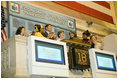 Mrs. Laura Bush is applauded as she stands over the New York Stock Exchange Monday, Sept. 18, 2006, where she visited to highlight literacy's role in extending the benefits of free enterprise to individuals around the world.