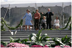 Mrs. Laura Bush joined by, left, Leone Reeder, Chair, National Fund for the U.S. Botanic Garden, and, right, Jim Hagedorn, Co-Chair, Board of Trustees, National Fund for the U.S. Botanic Garden, while the Ceremonial Garland is cut Friday, September 29, 2006, during a ceremony to celebrate the completion of the National Garden at the United States Botanic Garden in Washington, D.C. This new facility, located on a three-acre site just west of the Conservatory, will be a showcase for unusual, useful, and ornamental plants that grow well in the mid-Atlantic region.