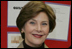 Mrs. Laura Bush embraces 10-year-old Taylor Rice, whose father is currently serving overseas in the Army Reserves, during a visit to the Learning Center at Andrews Air Force Base in Maryland, Wednesday, Dec. 5, 2007, where Mrs. Bush participated is a roundtable discussion on the special needs of military youth and families.