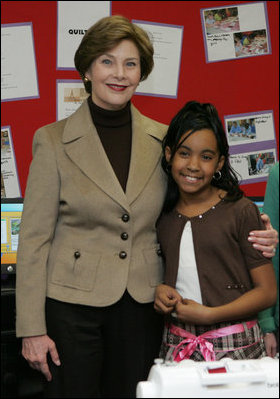 Mrs. Laura Bush embraces 10-year-old Taylor Rice, whose father is currently serving overseas in the Army Reserves, during a visit to the Learning Center at Andrews Air Force Base in Maryland, Wednesday, Dec. 5, 2007, where Mrs. Bush participated is a roundtable discussion on the special needs of military youth and families.