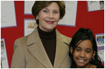 Mrs. Laura Bush embraces 10-year-old Taylor Rice, whose father is currently serving overseas in the Army Reserves, during a visit to the Learning Center at Andrews Air Force Base in Maryland, Wednesday, Dec. 5, 2007, where Mrs. Bush participated is a roundtable discussion on the special needs of military youth and families.