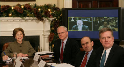 Mrs. Laura Bush is joined by Jim Jeffrey, Assistant to the President and Deputy National Security Advisor; Elliot Abrams, Deputy National Security Advisor for Global Democracy Strategy, and Dennis Wilder, Special Assistant to the President and Senior Director for East Asian Affairs, as she participates in a video conference on Burma in recognition of International Human Rights Day Monday, Dec. 10, 2007, in the Roosevelt Room of the White House. Speaking via video are U.S. Ambassador to Thailand Skip Boyce and Dr. Cynthia Maung, Founder and Director of the Mae Tao Clinic in Mae Sot,Thailand.