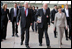 The Eiffel Tower stands tall in the background as Mrs. Laura Bush walks with Stephane Martin, President of the Musee du quai Branly, center, in Paris Monday, Jan. 15, 2007. Mrs. Bush toured the museum with US Ambassador Craig Stapleton, left, and his wife Mrs. Stapleton.