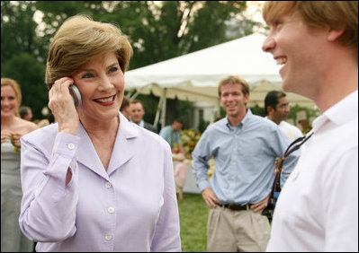 Mrs. Laura Bush surprises a caller on guest's cell phone Tuesday evening, June 19, 2007, at the annual White House Congressional Picnic on the South Lawn.