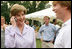 Mrs. Laura Bush surprises a caller on guest's cell phone Tuesday evening, June 19, 2007, at the annual White House Congressional Picnic on the South Lawn.