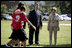 Mrs. Laura Bush and Mike Gottfried, CEO of Team Focus, watch Team Focus participants run a relay race Thursday, June 21, 2007, in Mobile, Ala., during a visit to Team Focus's National Leadership Camp, as part of Helping America's Youth initiative. Team Focus is a faith-based, nonprofit organization devoted to improving the lives of young men, ages 10-18, without fathers in their lives.