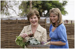 Mrs. Laura Bush and Ms. Jenna Bush pick vegetables during their visit to the Fann Hospital garden with Senegalese First Lady Viviane Wade and her daughter Tuesday, June 26, 2007, in Dakar, Senegal. Supported by USAID, the Fann Hospital gardens provide fresh vegetables to address the nutritional needs of patients with HIV/AIDS, an overlooked, but essential part of their care.