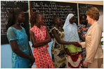 Mrs. Laura Bush meets Ambassador Girls' scholarship winners during a visit to Grand Medine Primary School Tuesday, June 26, 2007, in Dakar, Senegal. President Bush's Africa Education Initiative is working to provide 550,000 scholarships to girls throughout Africa by 2010. Pictured are, from left: Khady Diome, 15, of Diohine, Senegal; Fatou Djiby, 15, of Diakhao, Senegal; Christine Ndiaye, 14, of Diakhao, Senegal; Yamama Diop, 15, of Maroneme, Senegal; and Nango Dang, 16, of Thicky Serere, Senegal.