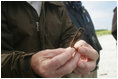 A Wildlife Biologist holds up a hook that was found in the stomach of a bird on Eastern Island. Human debris poses a significant danger to the many endangered species that live in the Midway Atoll National Wildlife Refuge.