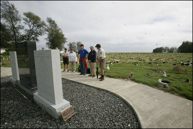 Mrs. Laura Bush visits the Battle of Midway Memorial on the parade grounds of Midway Island Thursday, March 1, 2007. Midway Atoll was the site of the World War II battle June 4, 1942. The U.S. Navy defeated a Japanese attack against Midway Islands, marking a turning point in the war in the pacific theater. Interior Secretary Dirk Kempthorne is pictured wearing a blue shirt and is standing next to Mrs. Bush.