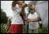 Mrs. Laura Bush tags an albatross chick during a visit to Midway Atoll Thursday, March 1, 2007. Interior Secretary Dirk Kempthorne is pictured with Mrs. Bush. President Bush designated the Northwest Hawaiian Islands National Monument on June 15, 2006, and is the single largest conservation area in U.S. history and the largest protected marine area in the world.