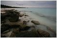 The sun sets over Rusty bucket beach after Mrs. Laura Bush's tour of Sand and Eastern Islands in Midway Atoll Thursday, March 1, 2007. President Bush designated the islands as a national monument June 15, 2006. It is the single largest conservation area created in U.S. history and the largest protected marine area in the world.