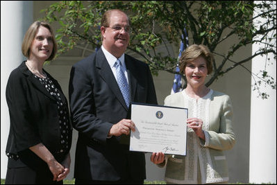 Mrs. Laura Bush poses with Mayor Wayne McCullen of Natchitoches, La., center, and Nancy Morgan, Cane River National Hertiage Area commission executive director, as she presents them with a 2007 Preserve America Presidential Award in the Rose Garden at the White House Wednesday, May 9, 2007, honored for their implementation of a comprehensive hertiage tourism plan for their region.