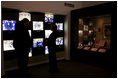 Mrs. Laura Bush, joined by Russell Caldwell, manager of visitor services at the Margaret Mitchell House and Museum in Atlanta, Ga., looks at a photo display showing images from the 1939 movie premiere of Gone with the Wind, during a tour of the famous author's home, Thursday, Nov. 1, 2007.