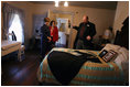 Mrs. Laura Bush, joined by her Chief of Staff Anita McBride, listens to Russell Caldwell, manager of visitor services, as he describes artifacts during a tour of the Margaret Mitchell House and Museum, Thursday, Nov. 1, 2007 in Atlanta, Ga. It was in this house that Mitchell wrote the novel, Gone with the Wind.