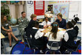 Mrs. Laura Bush shakes hands with student Taylor McIntyre, during her visit with students at the Good Shepherd Nativity Mission School, Thursday, Nov. 1, 2007 in New Orleans, a Helping America's Youth visit with Big Brother and Big Sisters of Southeast Louisiana. Captain Richard T. Douget, second from left, is a Big Brother to Taylor McIntyre.