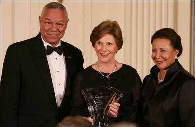 Mrs. Laura Bush is joined on stage by former Secretary of State Colin Powell and his wife, Alma Powell, as they present Mrs. Bush with a National Promise of America Founders Award, Tuesday evening, Nov. 13, 2007, during a social dinner to celebrate the tenth anniversary of America's Promise-The Alliance for Youth.