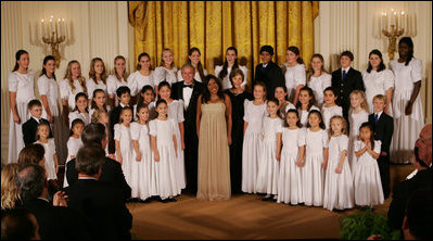 President George W. Bush and Mrs. Laura Bush join singer Melinda Doolittle, center, and members of the World Children's Choir on stage Tuesday evening, Nov. 13, 2007in the East Room of the White House, during the social dinner in honor of the tenth anniversary of America's Promise-The Alliance for Youth.