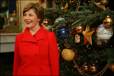 Laura Bush shows off the White House Christmas Tree during a press preview of the holiday decorations Thursday, Nov. 29, 2007, in the Blue Room. Decorated with 347 ornaments honoring the nation's national parks, the tree is an 18-foot Fraser fir presented to Mrs. Bush by Joe Freeman and Linda Jones of Laurel Springs, N.C. White