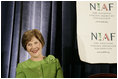 Mrs. Laura Bush smiles as she listens to an introduction by Dr. Ken Ciongoli , chairman of The National Italian American Foundation, during an education luncheon honoring Mrs. Bush with the NIAF Special Achievement Award in Literacy, Friday, Oct. 12, 2007 in Washington, D.C. In thanking the organization Mrs. Bush emphasized the many contributions that Italian-Americans have made in the education of our nation's youth.