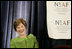 Mrs. Laura Bush smiles as she listens to an introduction by Dr. Ken Ciongoli , chairman of The National Italian American Foundation, during an education luncheon honoring Mrs. Bush with the NIAF Special Achievement Award in Literacy, Friday, Oct. 12, 2007 in Washington, D.C. In thanking the organization Mrs. Bush emphasized the many contributions that Italian-Americans have made in the education of our nation's youth.