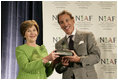 Mrs. Laura Bush is presented with The National Italian American Foundation's Special Achievement Award in Literacy from NIAF Chairman Dr. Ken Ciongoli, Friday, Oct. 12, 2007, in Washington, D.C.