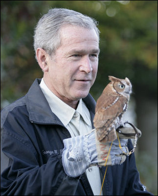 President George W. Bush holds a screech owl Saturday, Oct. 20, 2007 at the Patuxent Research Refuge in Laurel, Md., where President Bush discussed steps his Administration is creating for a series of cooperative conservation steps to preserve and restore critical stopover habitat for migratory birds in the United States.