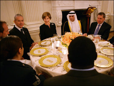 Mrs. Laura Bush speaks with guests at her table during the Iftaar Dinner with Ambassadors and Muslim leaders in the State Dining Room of the White House, Monday, Oct. 4, 2007.