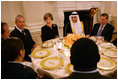 Mrs. Laura Bush speaks with guests at her table during the Iftaar Dinner with Ambassadors and Muslim leaders in the State Dining Room of the White House, Monday, Oct. 4, 2007.